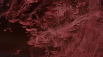 Red paint on the dark background Stock Footage 85843467