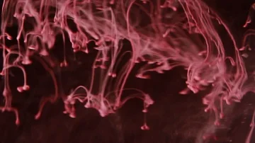 Red paint on the dark background Stock Footage 85843477