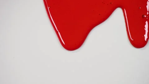 Red paint drains in waves across grey surface Video stock 266649147