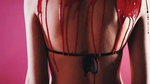 Red paint flows down the back of the girl Stock Footage 81699840