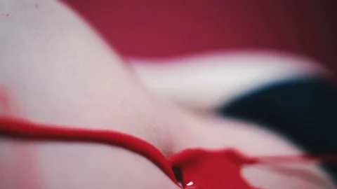 Red paint flows over the belly of a girl Stock Footage 81698178