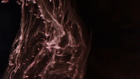 Red paint mixed paint on a black background Stock Footage 85843451