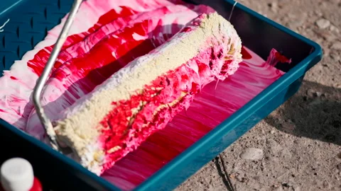 Red paint mixed with white paint in tray for paint. Slowmotion 動画素材 155078763