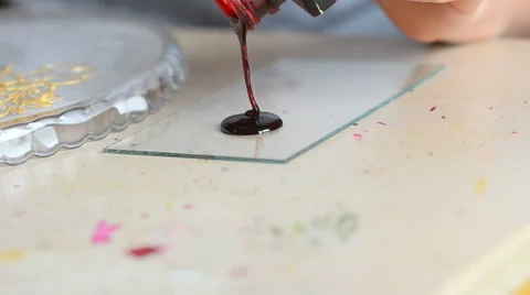 Red paint is pouring from a paint jar Stock Footage 65792007