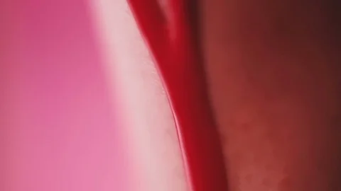 Red paint slowly drains over the female leg Stock Footage 81698053