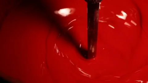 Red paint is stirring in the vat. Video stock 73195531