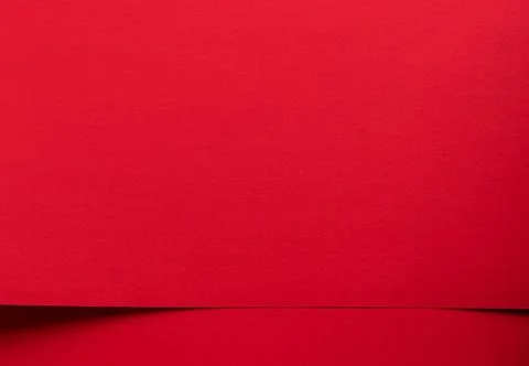 Red paper background with a subtle horizontal fold. Minimal textured surfac.. 库存照片