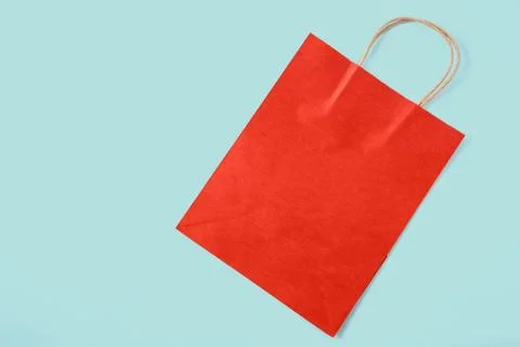 Red paper bag on colored background. top view Stock Photos