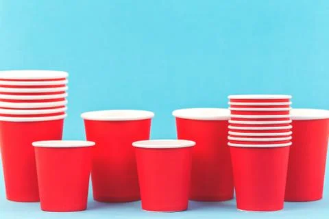 Red paper cups rows on blue background Stock Photos