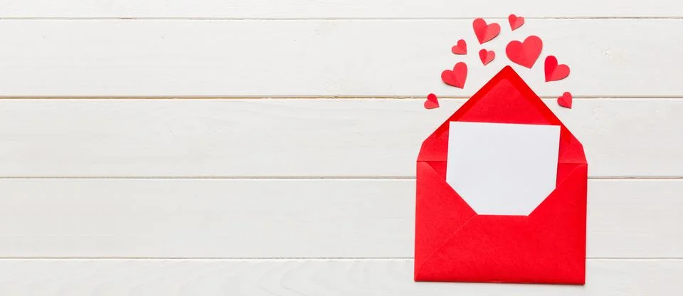 Red paper envelope with empty white card and heart on colored background. top Stock Photos