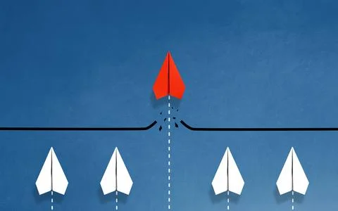 Red paper plane breaking through obstacle on blue background, Concept of ov.. Stock Photos
