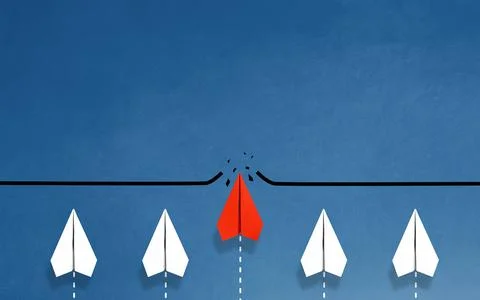 Red paper plane breaking through obstacle on blue background, Concept of ov.. Stock Photos