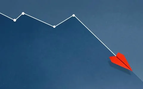 Red paper plane flying downward along a line graph on a blue background. Cr.. Stock Photos