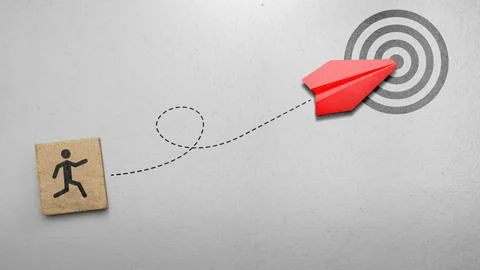 A red paper plane follows a loop trajectory from a running man icon to hit .. Stock Photos