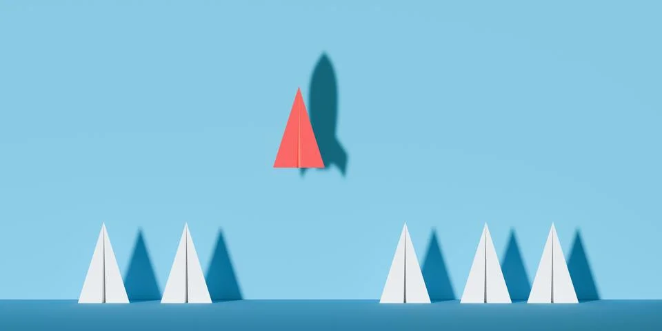 Red paper plane with rocket shadow above standing group of white paper plan.. Ilustração Stock