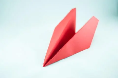 Red paper plane on a white background, isolated.  Stock Photos