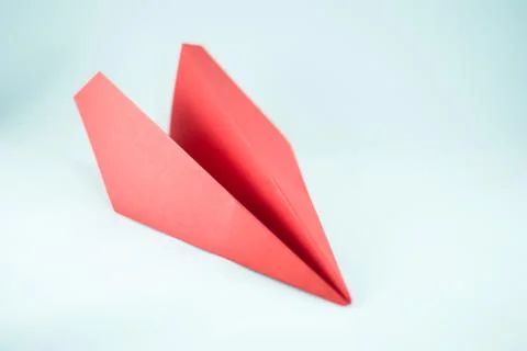 Red paper plane on a white background, isolated.  Stock Photos