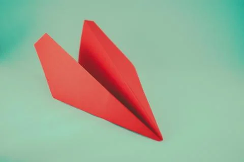 Red paper plane on a white background, isolated. Concept (idea) of airlines,  Foto stock