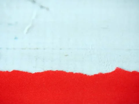 Red paper with torn edges placed on a white background. Stock Photos