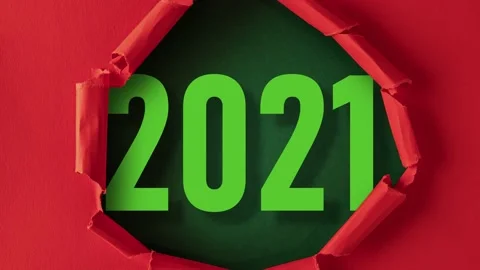 Red paper is torn over 2021 on green background, stop motion, animation. Stock Footage 145475010