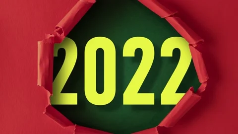 Red paper is torn over 2022 on green background, stop motion, animation. Stock Footage 150353952