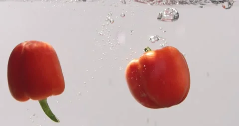 Red paprika floating in the saucepan Stock Footage 148822166