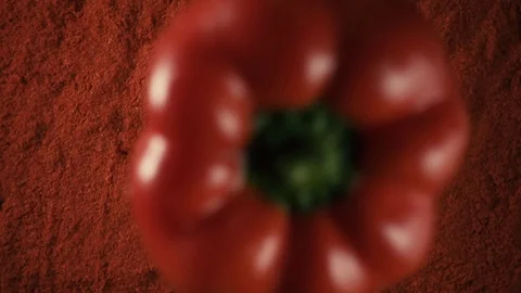 Red paprika pepper drops on pepper powder, slow motion, top view Stock Footage 74414246