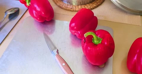 Red paprika pepper lies on a kitchen cutting board. Stock Footage 343685813