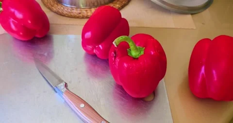 Red paprika pepper lies on a kitchen cutting board. Stock Footage 343685826