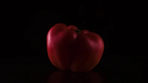 Red paprika on the table sprinkled with powder. Slow mo Stock Footage 74414166