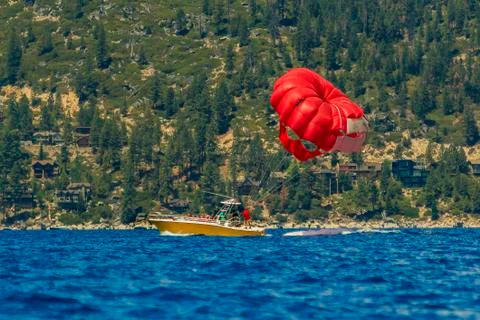 Red parasail wing pulled by a boat on lake Tahoe in California, USA Фото
