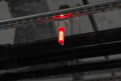 Red parking sensor on ceiling - space is taken. Smart parking concept. Stock Photos