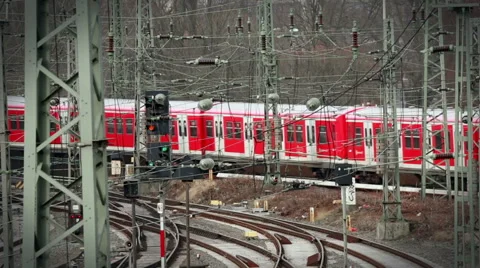 Red passenger train approaching train station Stock Footage 67677213