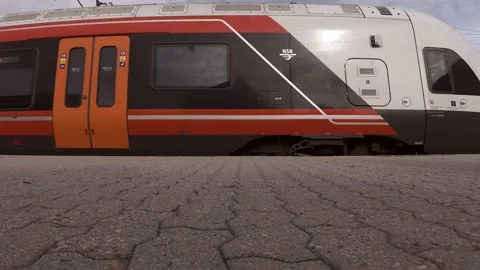 Red passenger train pulls into station Stock Footage 136079947