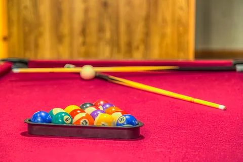 Red pastel pool table with balls in a rack Stock Photos