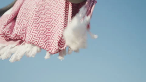 Red patterned towel blowing in the wind on a sunny day. Great for summer Stock Footage 285075409