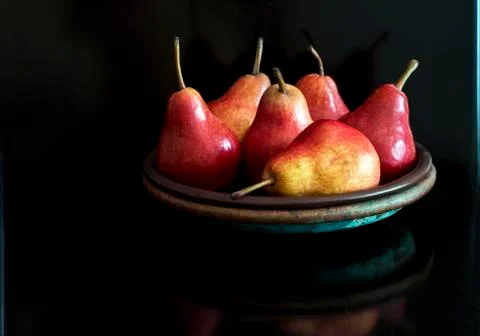 Red pears on a plate Stock Photos
