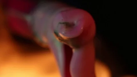 A red pen cap melting from high heat - macro - MRYT Stock Footage 74334618