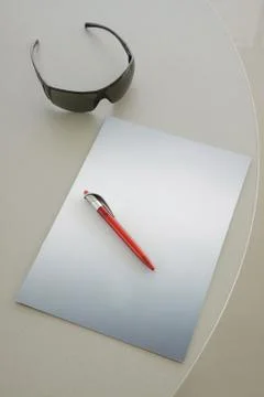 Red Pen on a grey notebook Stock Photos