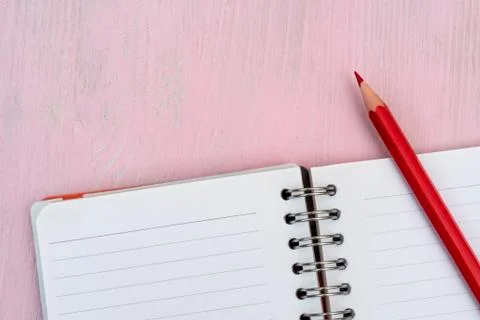 Red pencil and notebook for notes. Stock Photos