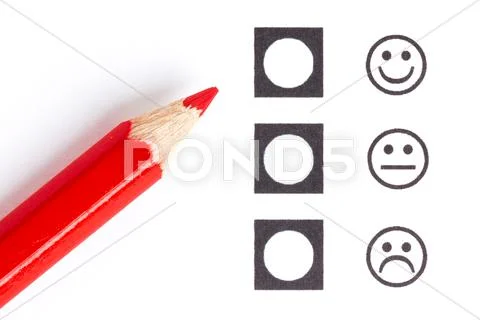 Red pencil choosing the right smiley Stock Photos