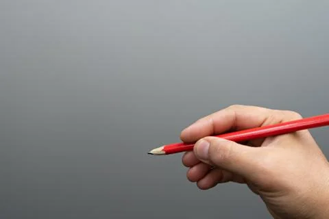 Red pencil on gray background 写真素材