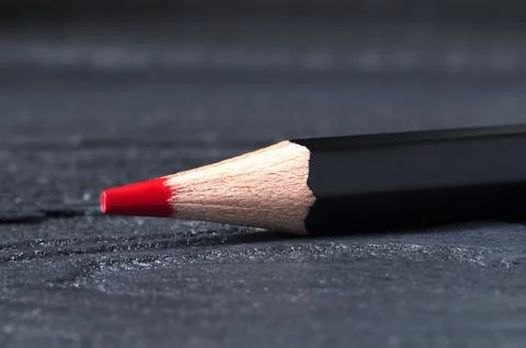 A red pencil is lying on the table. Close-up Stock Photos