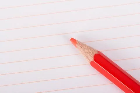 Red pencil on notebook Stock Photos