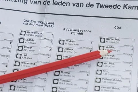 A red pencil is shown hovering over a Dutch ballot paper for the Tweede Kamer Stock Photos