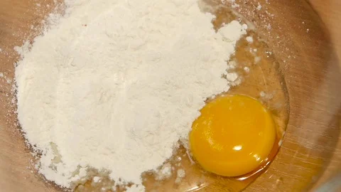 Red pepper is added to egg with flour, slow motion Stock Footage 76166792