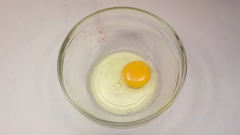 Red pepper is added to plate with egg, slow motion Stock Footage 76147938