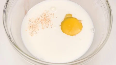 Red pepper is added to plate with milk and egg Stock Footage 76144963