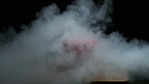 Red pepper on a black background, in smoke. Slow motion Stock Footage 300678232