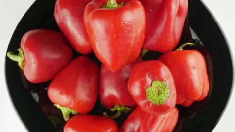 Red pepper on a black plate.Rotate in a circle close-up. Stock-Footage 140090302